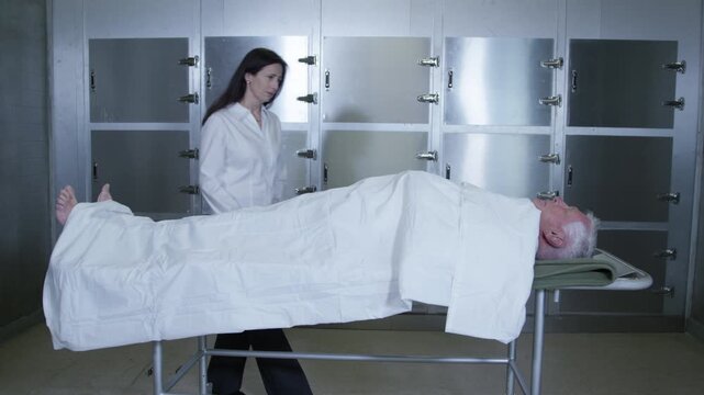 A corpse on a gurney in a hospital morgue