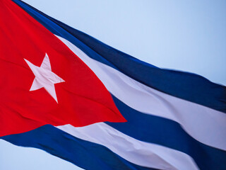 Cuba Flag Waving on flagpole. Cuba flag flaping in wind. Close-up of an Cuban flag flying in the wind against a background of clear sky. Cuba flag Dramatic look, bottom view