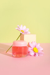 Jar of cosmetic product, plaster podium and flowers on color background