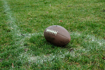 An American football in the corner of the field