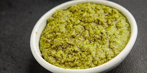 Pesto sauce basil, olive oil, parmesan, pine nuts, garlic natural product tasty snack fresh delicious gourmet food background on the table rustic top view copy space