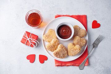 Potato croquette in the form of hearts with ketchup sauce for Valentine-s day holidays