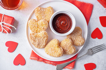 Potato croquette in the form of hearts with ketchup sauce for Valentine-s day holidays