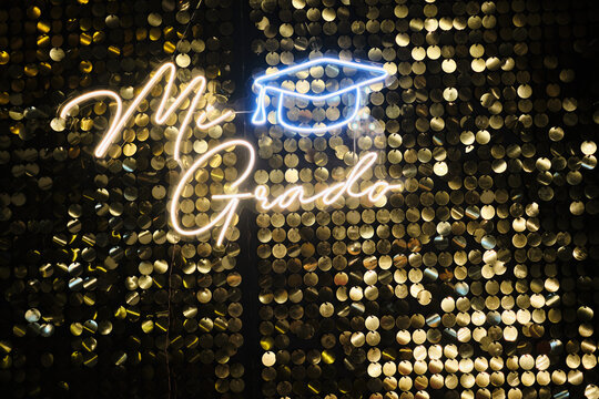 Mi grado neon sign on golden sequin backdrop