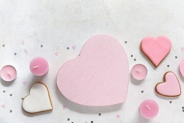 Heart shaped cookies and candles on white background. Valentine's Day celebration