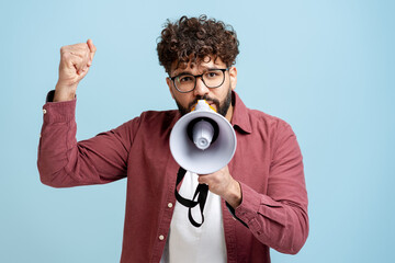 Man activist shouting message into megaphone with raised fist for protest