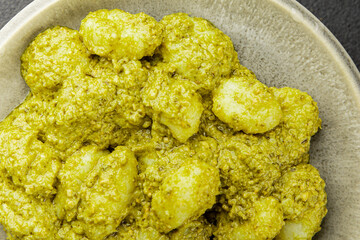 Gnocchi pesto sauce green tasty snack fresh gourmet food background on the table rustic top view copy space vegerian and vegan food