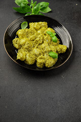 Gnocchi pesto sauce green tasty snack fresh gourmet food background on the table rustic top view copy space vegerian and vegan food