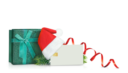 credit card with a Santa hat, a gift box and Christmas tree branches are isolated on a transparent background.