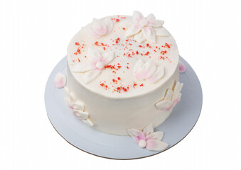 A delightful white cake adorned with delicate floral designs and bright red sprinkles sits on a light blue plate, perfect for a celebration or gathering