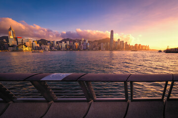 Awesome view of Victoria Harbour and Hong Kong's fantastic skyline, with its impressive skyscrapers, against dramatic sunset and sky, Hong Kong, China