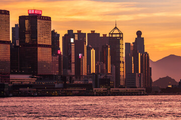 Scenic, awesome view of Hong Kong's fantastic skyline, with its impressive skyscrapers, against a dramatic sunset and sky, Hong Kong, China