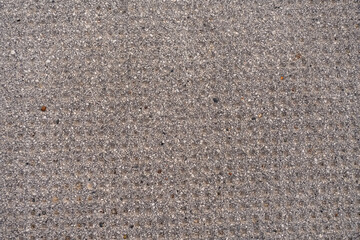 Uniform gray concrete texture with small stones as a neutral background for design projects