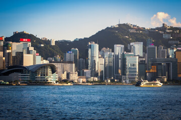 Beautiful, scenic day view of the Hong Kong Convention and Exhibition Centre, which is nestled among tall skyscrapers in Hong Kong, SAR, China