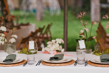 Coziness and style. Modern event design. Table setting at wedding reception. Floral compositions...