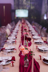 Coziness and style. Modern event design. Table setting at wedding reception. Floral compositions...