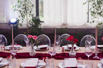 Coziness and style. Modern event design. Table setting at wedding reception. Floral compositions...