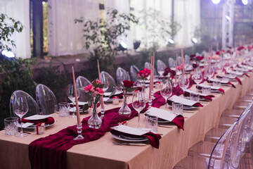Coziness and style. Modern event design. Table setting at wedding reception. Floral compositions...