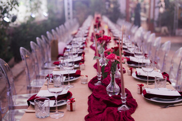 Coziness and style. Modern event design. Table setting at wedding reception. Floral compositions...