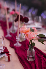 Coziness and style. Modern event design. Table setting at wedding reception. Floral compositions...
