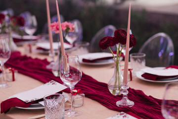 Coziness and style. Modern event design. Table setting at wedding reception. Floral compositions...