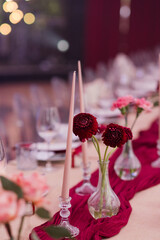 Coziness and style. Modern event design. Table setting at wedding reception. Floral compositions...