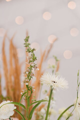 Coziness and style. Modern event design. Table setting at wedding reception. Floral compositions...