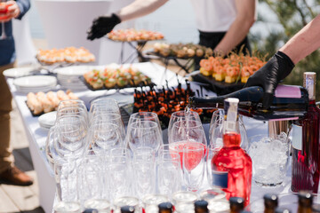 Catering banquet table at reception. Restaurant presentation, european cuisine, food consumption, party concept. Food styling, appetizers bar, welcome drink, event design.