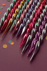 Fragment of old vintage Christmas ornaments glass icicles, close-up top view on purple background, selective focus