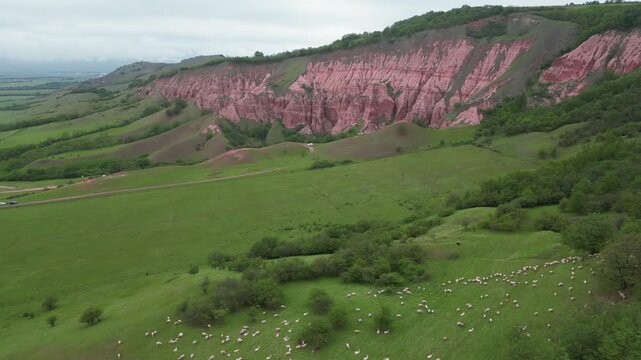 Stunning aerial view of the Red Ravine, a unique natural monument with a flock of sheep grazing
