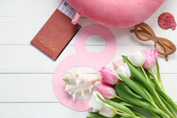 Composition with paper figure 8, passport and tulip flowers for International Women's Day on light wooden background