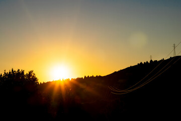 Scenic sunset in mountains and distant power lines
