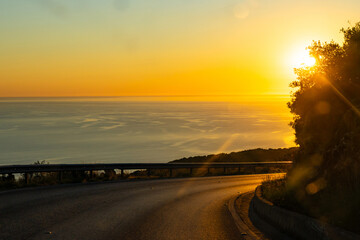 Turn of a mountain road along the Mediterranean sea coast during sunset in a nice summer evening
