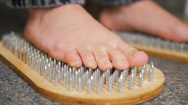close-up of a woman's feet standing on a board Sadhu