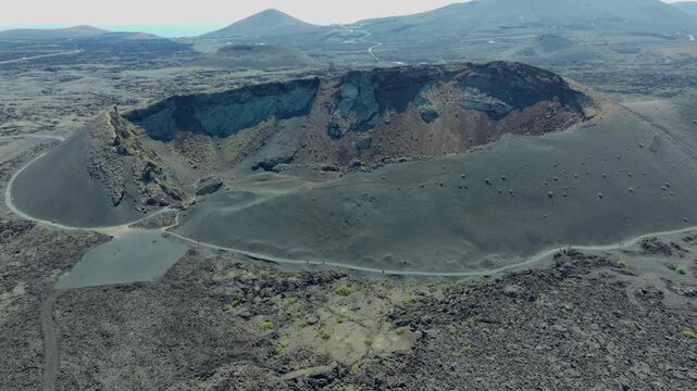 Aerial view of the El Cuervo volcano, an impressive crater surrounded by a volcanic landscape, Lanzarote, Canary Islands.   