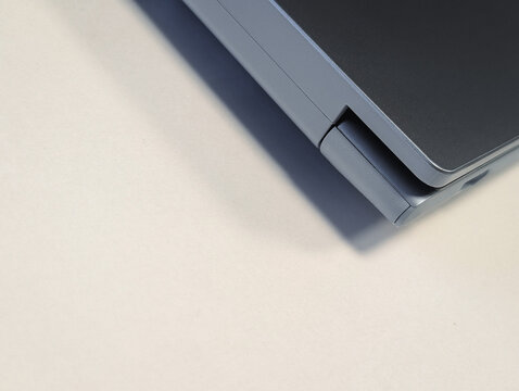 close up of modern laptop hinge mechanism on a light grey background