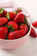 Bowl with sweet fresh strawberries on white background