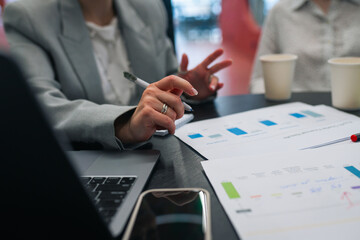 Colleagues discussing marketing data charts and KPIs in office meeting, teamwork and strategy development