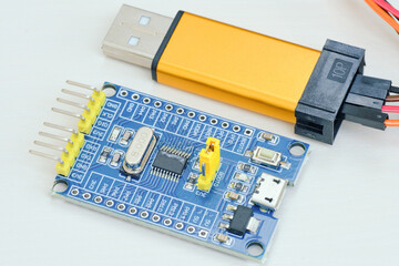 Fototapeta premium Programming board of Arduino UNO in blue colour isolated in white background