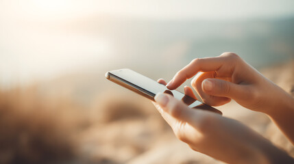 A person uses a smartphone outdoors, capturing a moment in a serene, natural landscape.