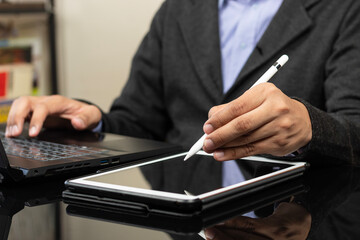 a modern business man working from home ready to draw something on a white tablet with a digital pen