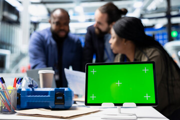 Diverse engineering team sharing their expertise with isolated screen in solar facility, advancing...