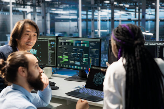 Team of engineers working in server farm with hardware supporting advanced analytics tasks and data mining. Data center teamworking colleagues doing maintenance on racks storing blockchain records - Powered by Adobe