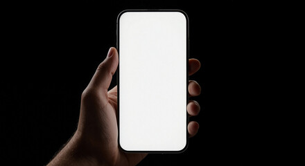 Hand showing smartphone with blank screen isolated on black background. Concept for business...