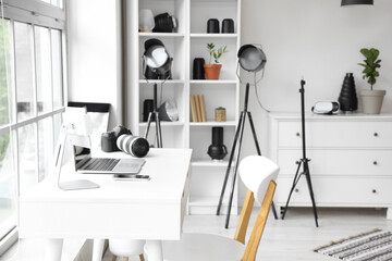 Modern gadgets on photographer's desk in office