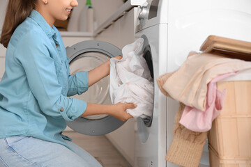 Young woman doing laundry  at home