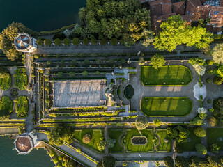 High-angle drone view directly over the elaborate, geometric Italianate terraced gardens (Teatro Massimo) and baroque architecture on Isola Bella, one of the Borromean Islands