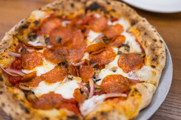 Spicy sausage pizza with cheese and tomato