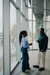 Colleagues having coffee break and discussing in office