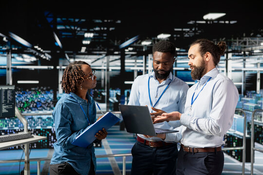 Computer scientists in data center monitoring neural network AI systems, reviewing LLM visualization. Industrial server hub staff overseeing machine learning processes, server clusters.